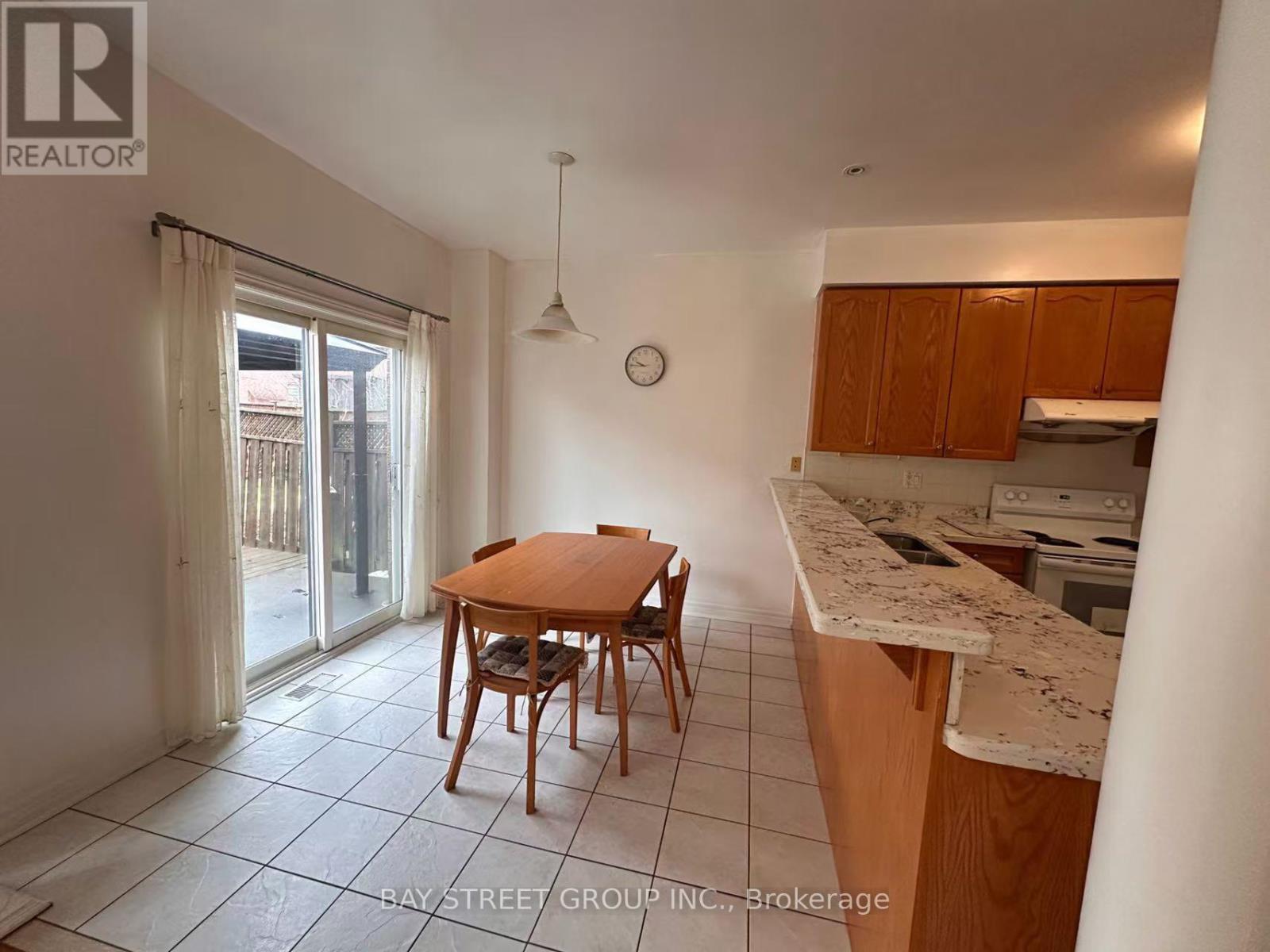 A kitchen with a table and chairs in the middle of the room.