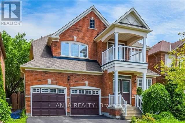 A two-story brick house with a balcony on the second floor.