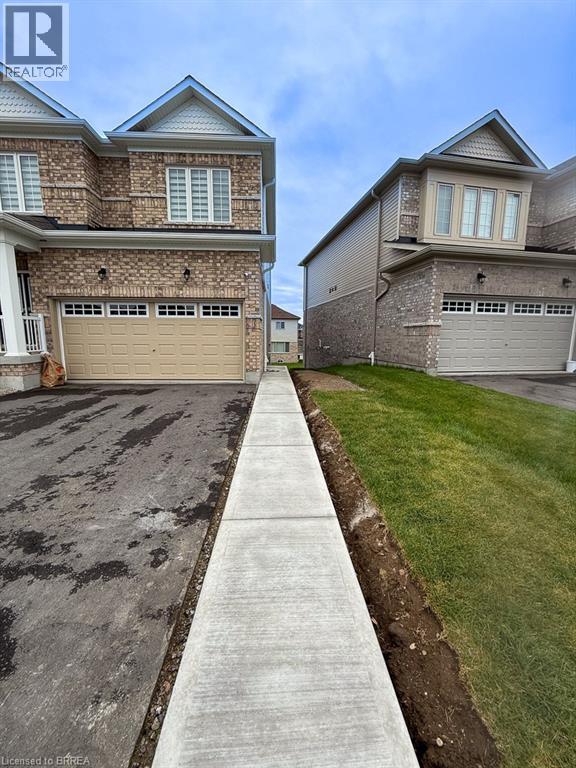 A residential area with houses and a concrete pathway.