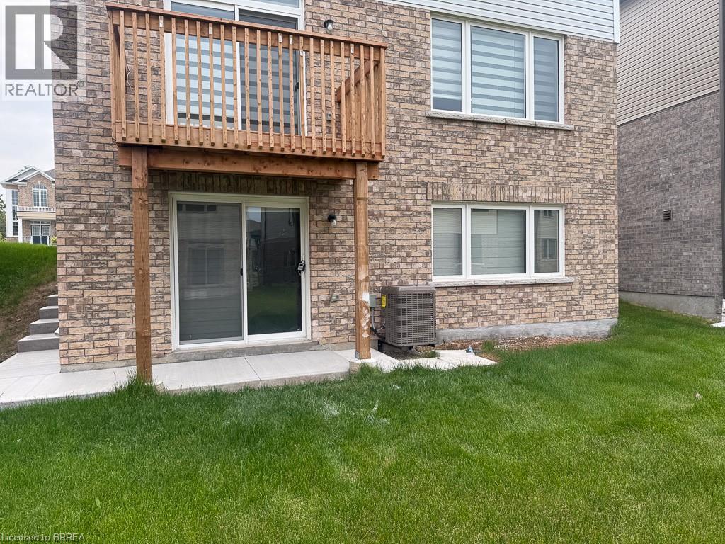 A house with a balcony and a brick wall.