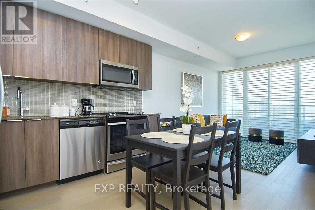 A kitchen with a dining table and chairs.