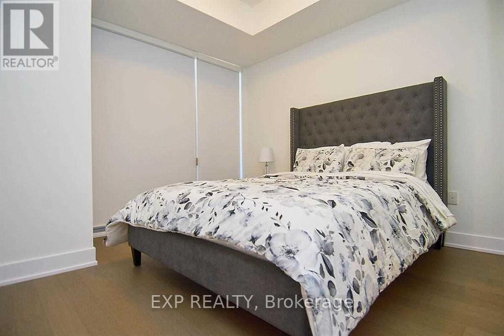 A bedroom with a large bed and a floral comforter.