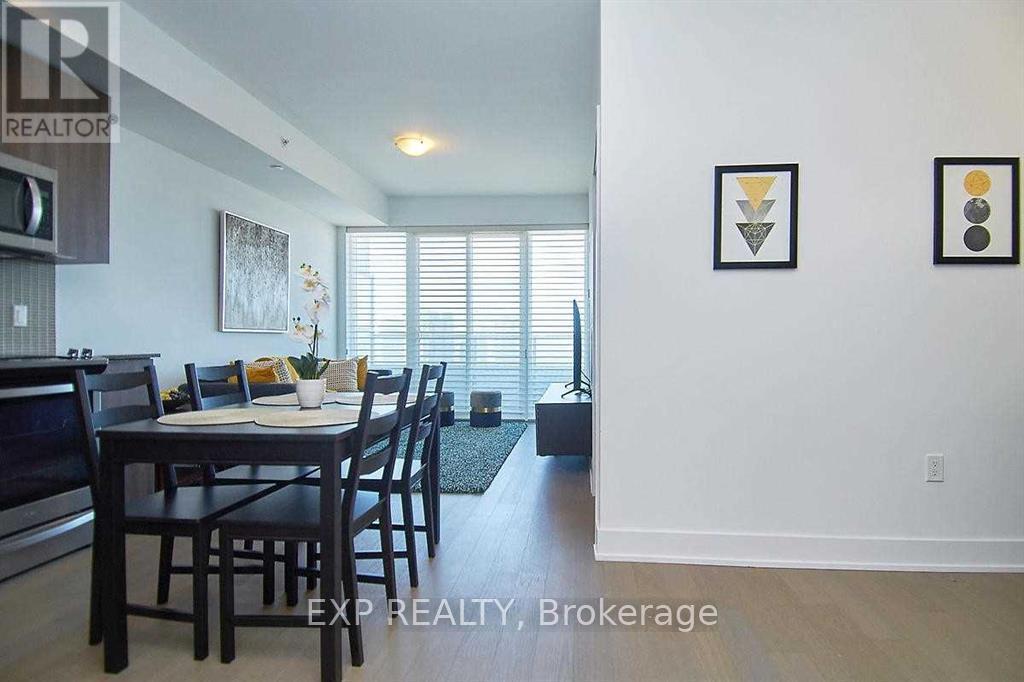 A dining room with a table and chairs.
