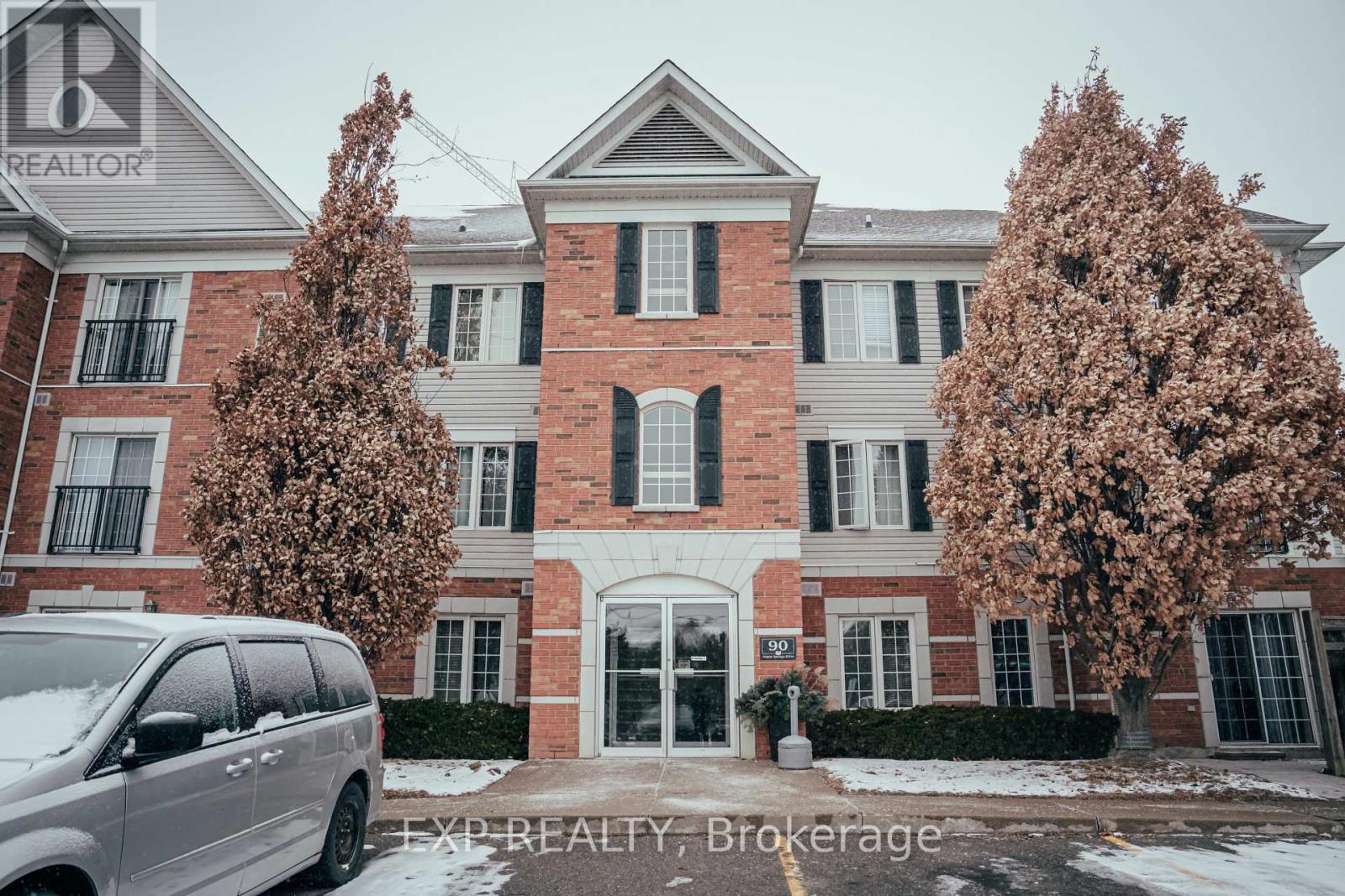 A large brick building with a sign that says EXP REALTY, Brokerage.