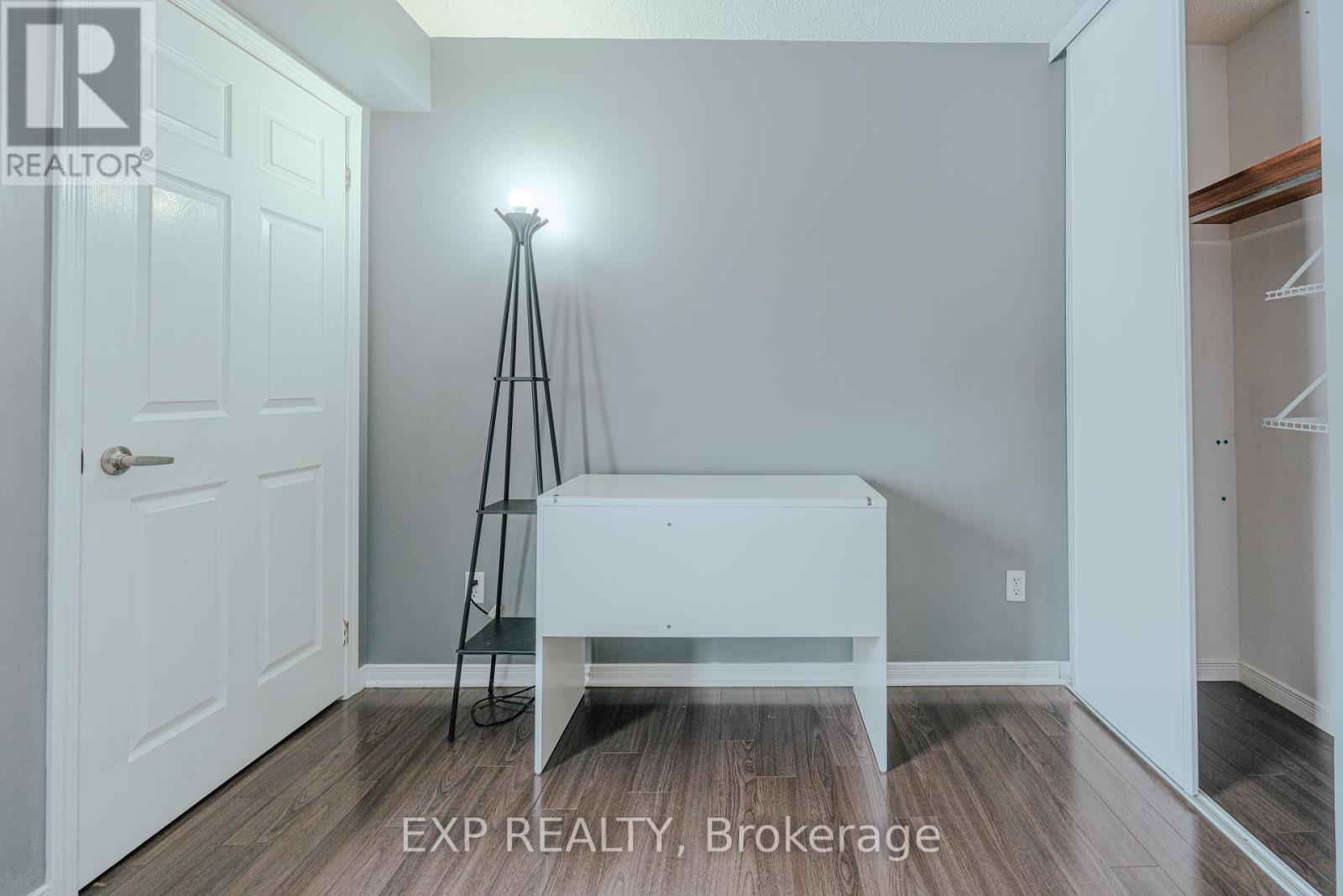 A bedroom with a bed and a lamp.
