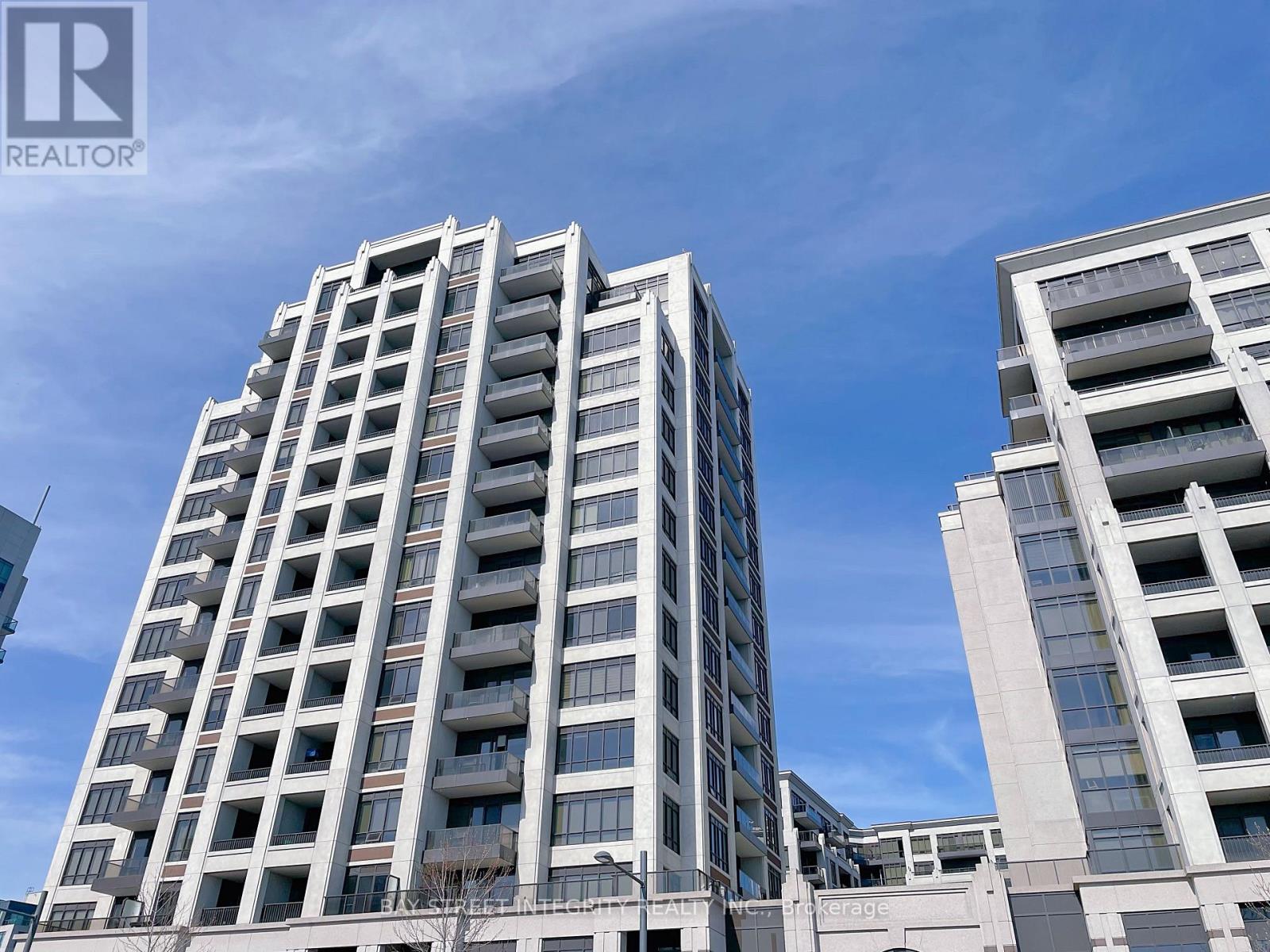 A tall residential building with multiple balconies and windows.