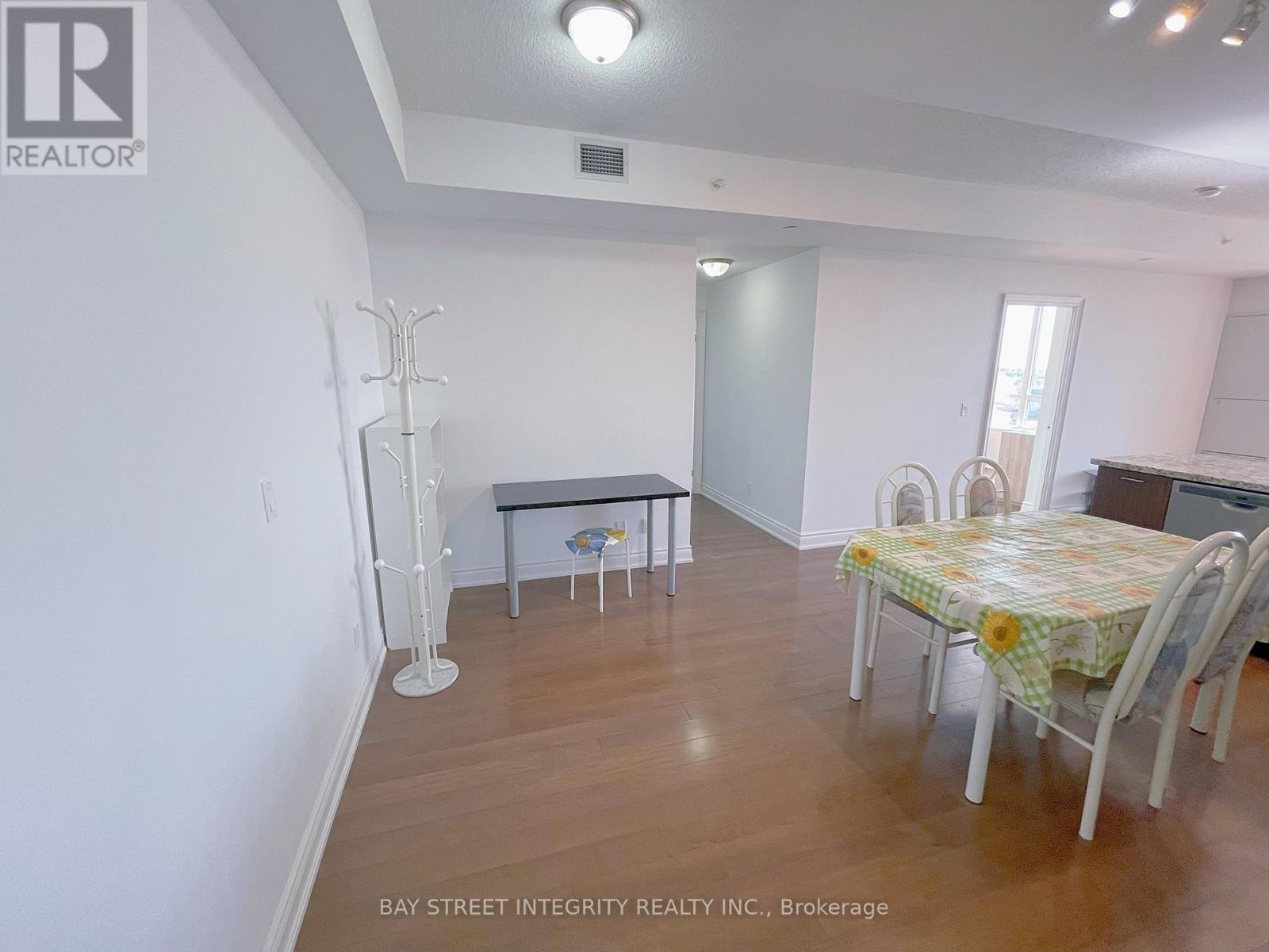 A dining room with a table and chairs.