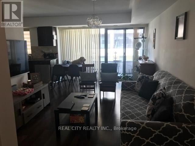 A living room with a couch, chairs, and a coffee table.