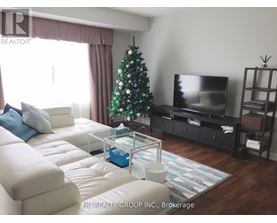 A living room with a Christmas tree and a flat screen TV.