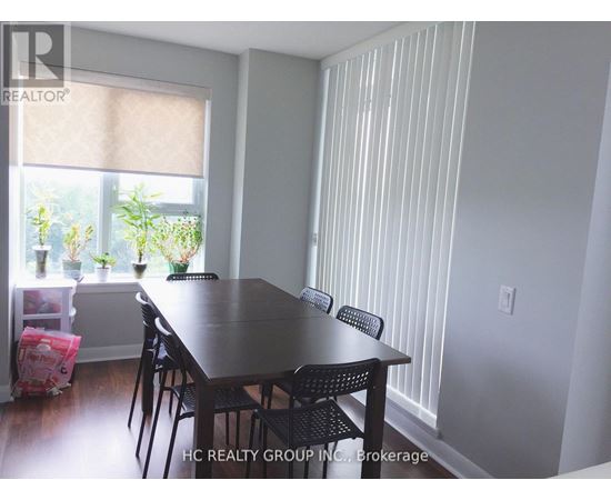 A dining room with a table and chairs.