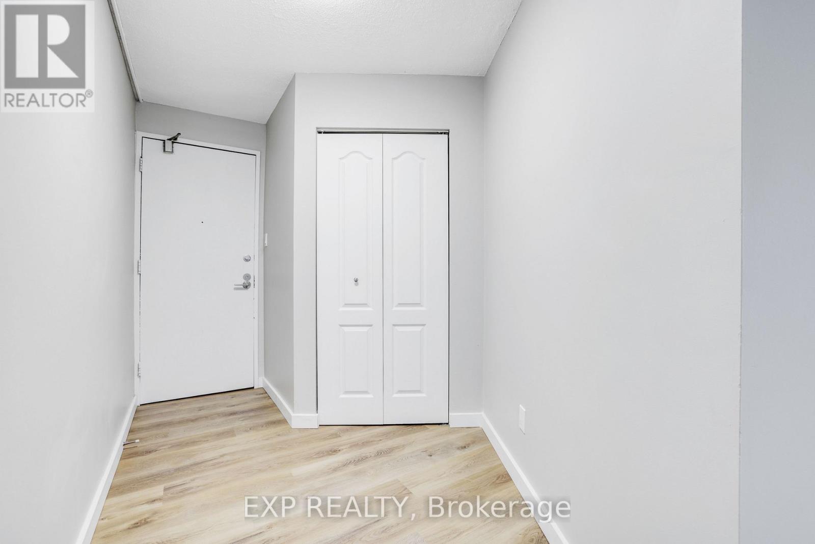 A room with a white door and a white wall.
