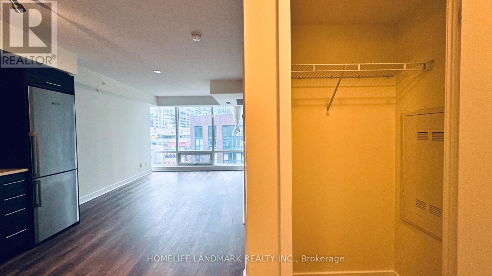 A brokerage office and a bedroom with a closet.