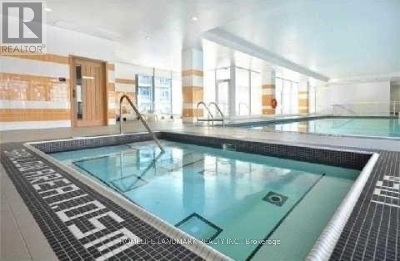 A large indoor swimming pool with a tiled edge and a black and white border.