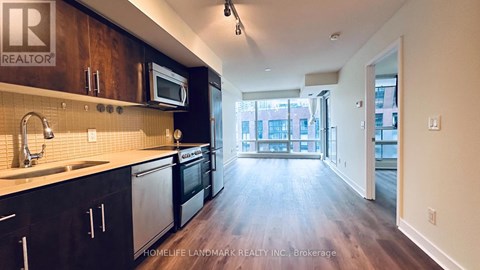 A kitchen with wooden cabinets and a sink.