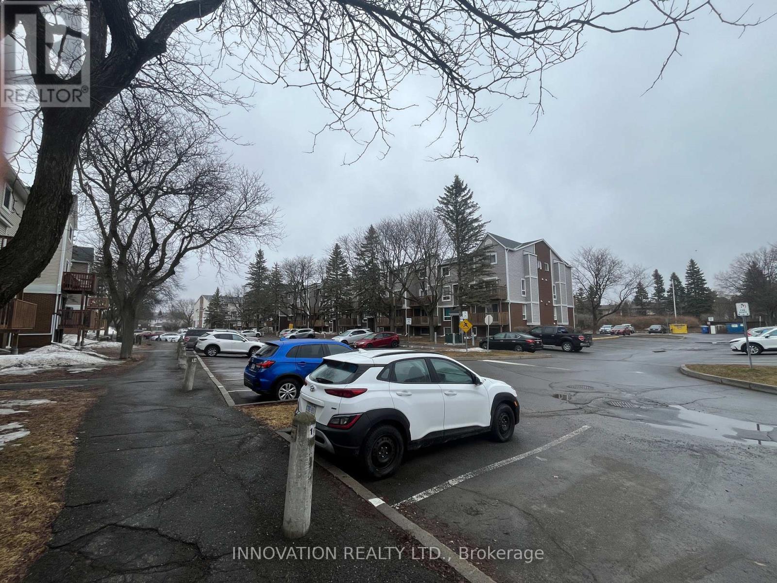A white car is parked in a parking lot.