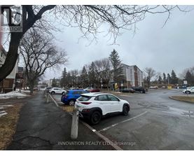 A white car is parked in a parking lot.