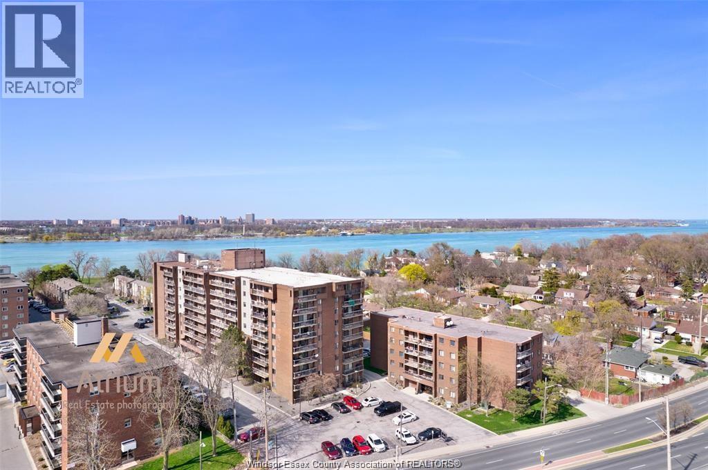A real estate photograph of a residential area with apartment buildings and a parking lot.