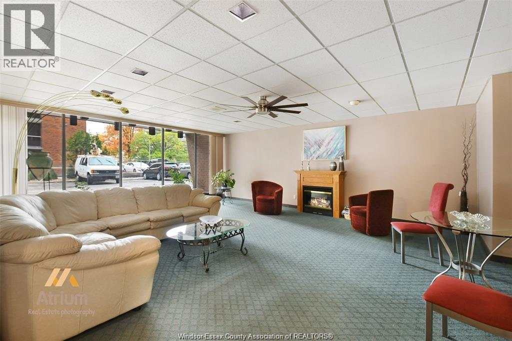 A living room with a sofa, chairs, and a fireplace.