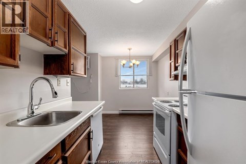 A kitchen with wooden cabinets and a white countertop.
