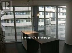 A real estate office with a view of a building outside the window.