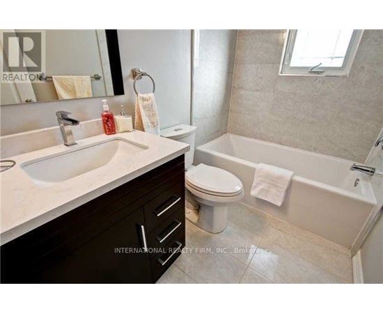 A bathroom with a white sink, toilet, and bathtub.