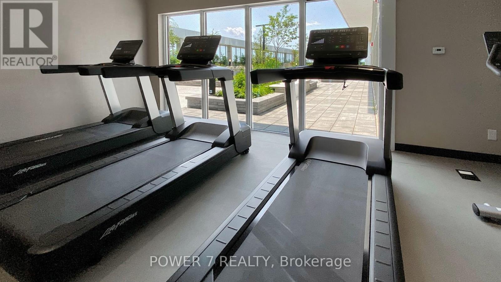 A gym with treadmills and a sign that says "REALTOR".