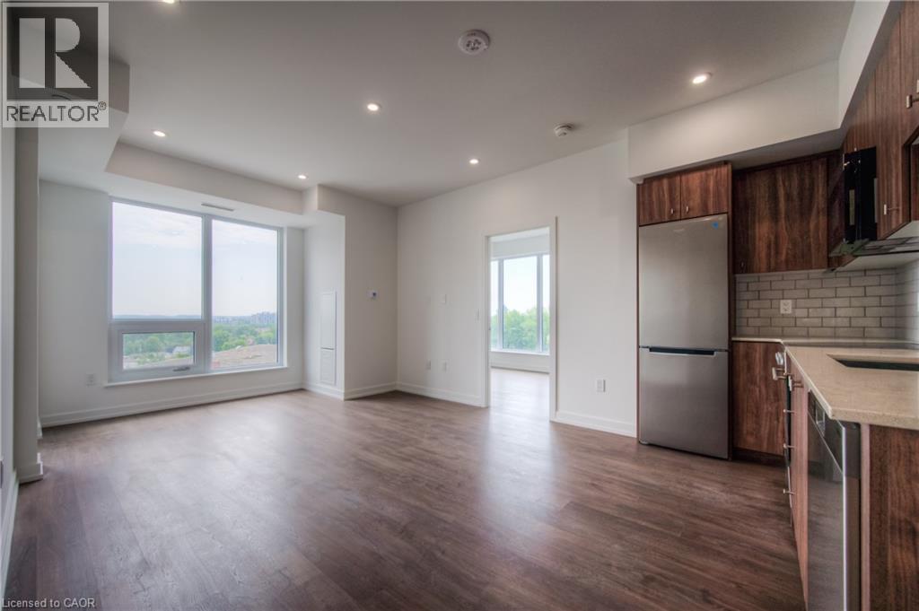 A spacious kitchen with wooden cabinets and a stainless steel refrigerator.
