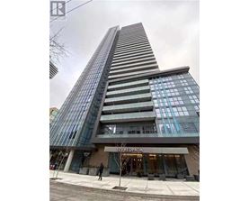 A tall building with a glass facade and a sign that reads "125 REDPATH" in front of it.