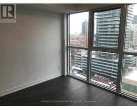 A room with a large window overlooking a cityscape.