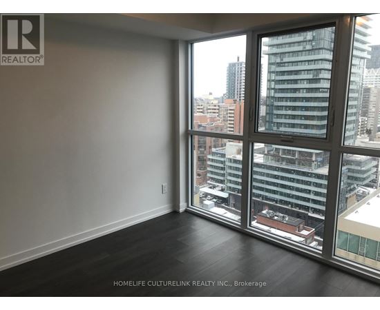 A room with a large window overlooking a cityscape.