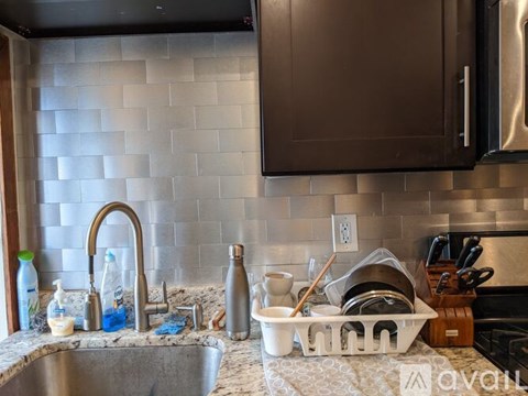 A kitchen sink with a lot of dishes in front of it.