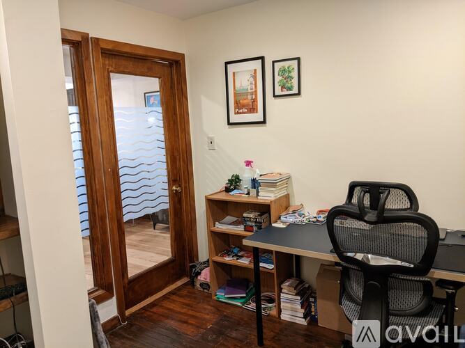 A room with a desk and chair in it.