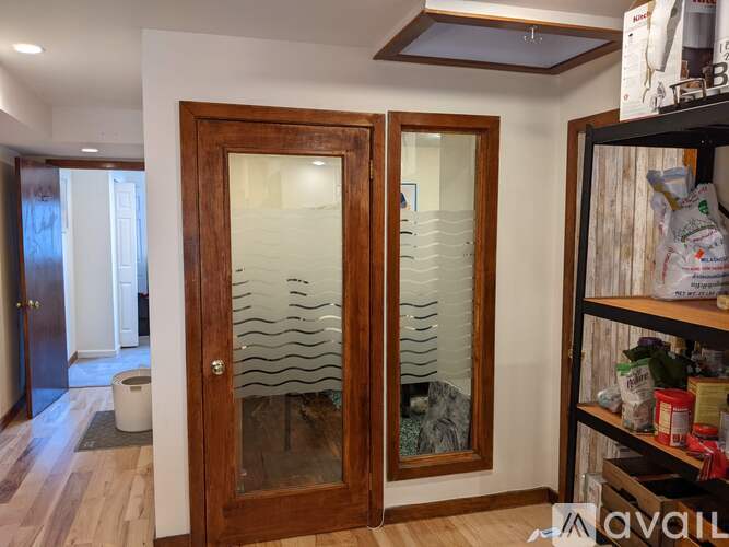 A room with a wooden floor and a glass door.