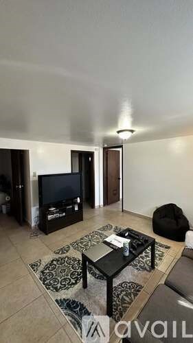 A living room with a black coffee table and a television.