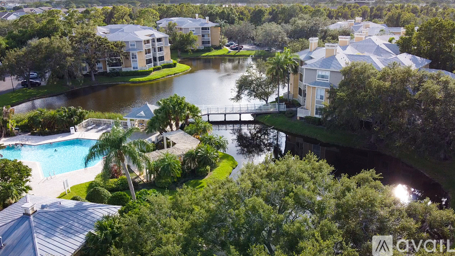 A bird's eye view of a resort with a pool and a bridge.