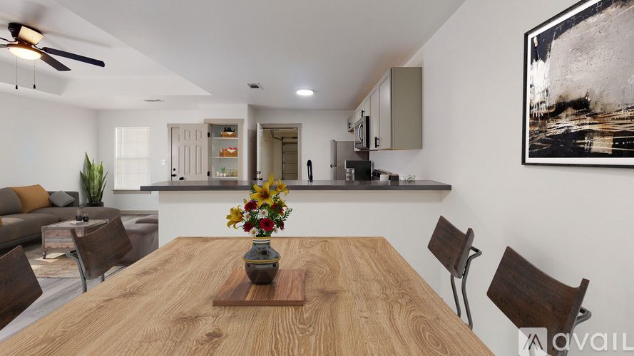 A dining room with a wooden table and chairs.