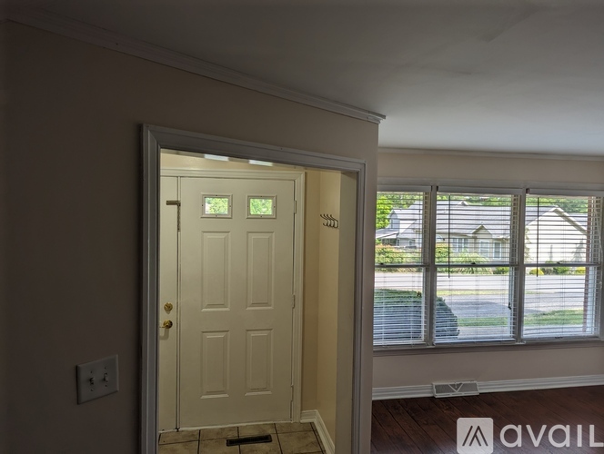 A white door with a glass window on the right side.