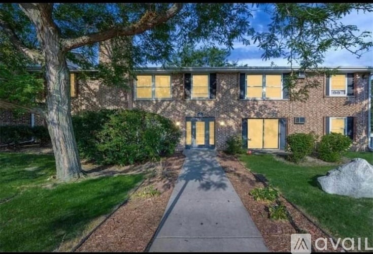 A building with a tree in front of it.