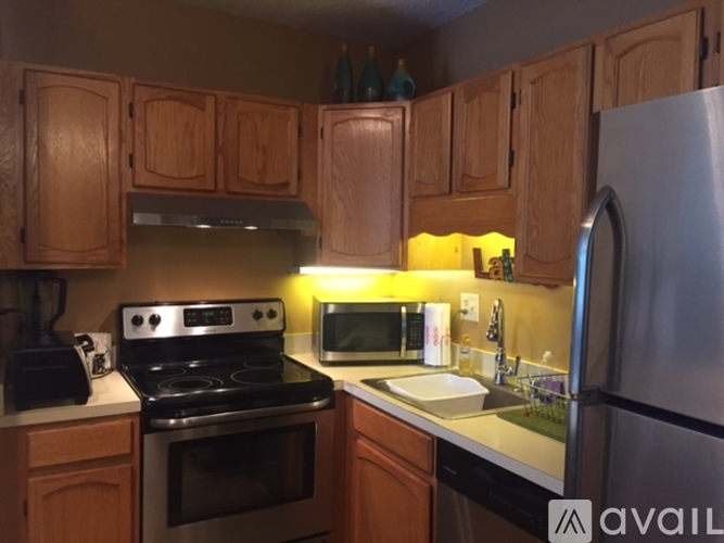 A kitchen with wooden cabinets and stainless steel appliances.