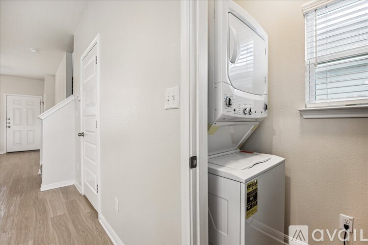 A white microwave is on a counter in a kitchen.