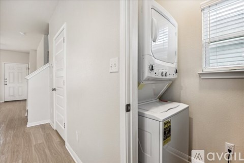 A white microwave is on a counter in a kitchen.