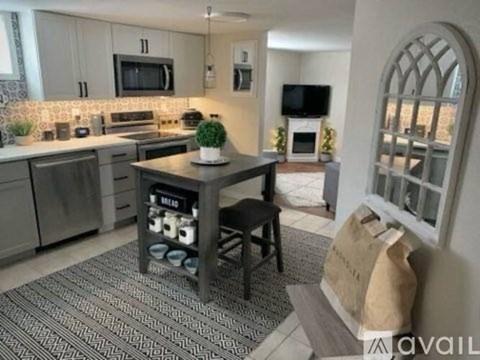 A kitchen with a table and chairs in the middle of the room.