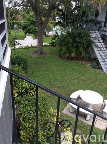 A white toilet is on a patio.