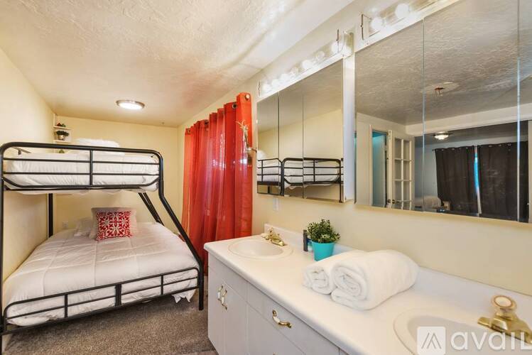 A bedroom with a bunk bed and a vanity with a mirror.