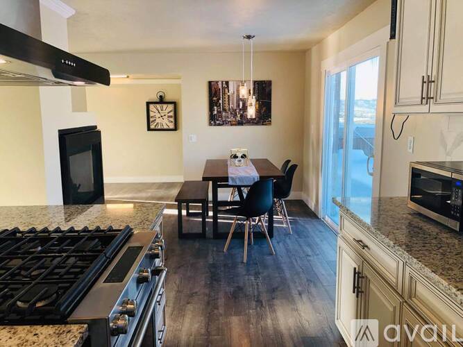 A kitchen with a black stove top oven and a black microwave above it.