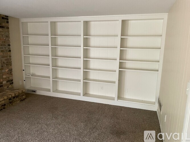 A large white built-in shelving unit in a room.