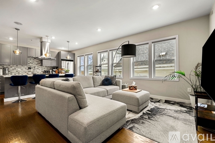 A modern living room with a grey sofa set and a black floor lamp.