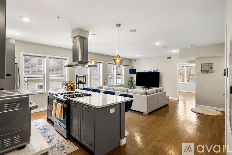 A modern kitchen with a large island and stainless steel appliances.
