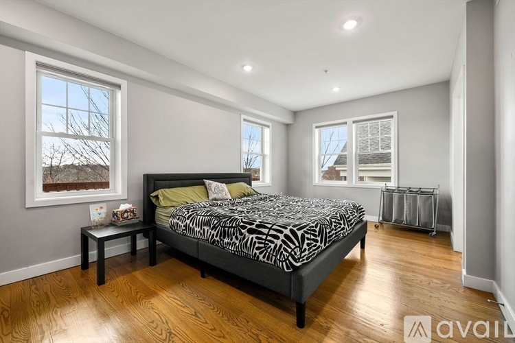 A bedroom with a large bed and a small table.