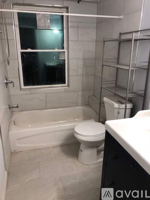 A bathroom with a toilet, sink, and bathtub.